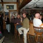 Garo again (He gets around) seated at the bar with Drumstir on his left, and Bubba to his right. 