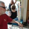 Here is Spike sitting at Tommy's Tiki Hut with a beach
game called something like 
Hang The Ring On The Hook.
This is a game on a surf board 
That we play at Dusty's Yacht
Club on Portage Lakes. However, there the hook is on the wall.
