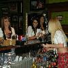 Tilted Kilt waitresses getting their drink orders from AMELIA at the bar. 