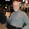 Here is S.B. (Skinny Boy) embibing in a Glennlevit scotch.
Yes, the pciture is blurred.
 But when I took it from the
 bar it seemed in focus to
 me. Is it me or does he
 look like a skeleton with 
that smile?