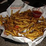 These were FERGIE'S fries AFTER 
he ate quite a few of them with his Wrap.
Too many Fries. Why do they do this? 