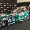 Mr. Lobber standing next to the
race car of the NHRA  Funny
Car Division.