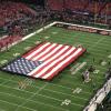 An American Flag was draped
over the field before the start
of the gmae in anticipation of
the singing of the National
Anthem.