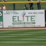 AN  ADVERISEMENT ON A SIGN ON THE OUTFIELD FENCE. I USED TO PLAY IN A BAND MANY MOONS AGO CALLED THE "ELITES"!