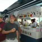 Buffalo and Jim Bob in front of a stand at Tucson Electric Park.