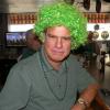 Here is our Entertainment Director R. B. reluctantly wearing the wig I bought 
for St. Patty's Day fresh 
out of the bag. I got it for anyone that wanted it. We thought R. B. NEEDED it!